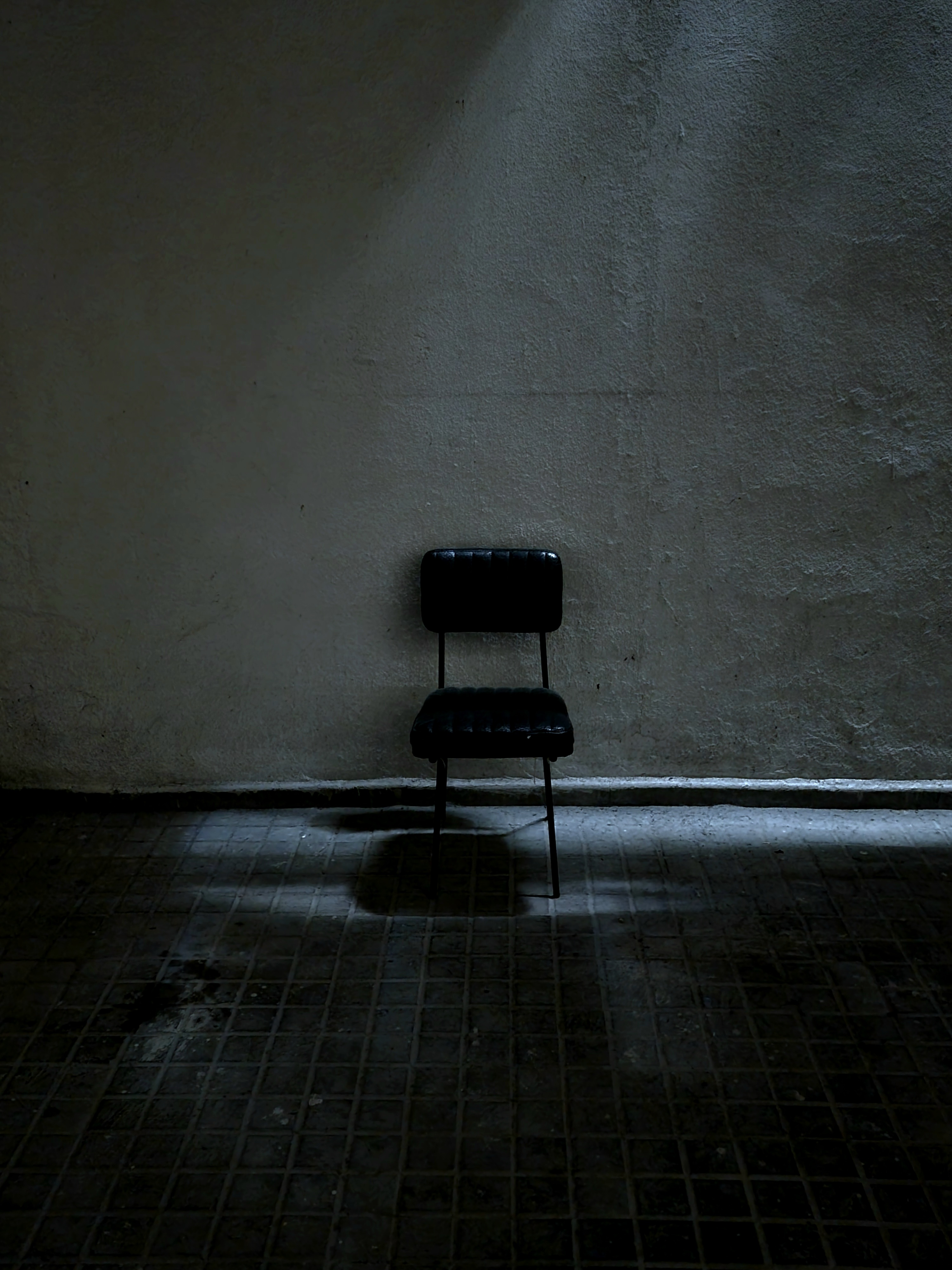 a chair in a dark, creepy space.